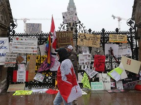 The front gate of Parliament of Canada is covered with banners as demonstrators continue to protest the vaccine mandates on February 17, 2022 in Ottawa, Canada.