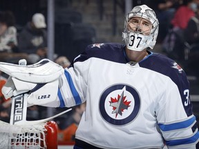 Connor Hellebuyck of the Winnipeg Jets looks on during the second period against the Philadelphia Flyers at Wells Fargo Center on Tuesday.
