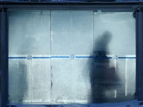 A person stands in a bus shack during extreme cold in Winnipeg on Wednesday afternoon. Chris Procaylo/Winnipeg Sun
