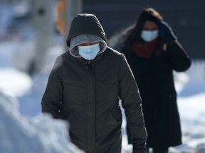 People wear masks while in public in Winnipeg on Friday. Feb. 4. 2022.