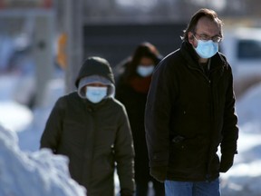 People wear masks while in public in Winnipeg on Friday, Feb. 4, 2022.