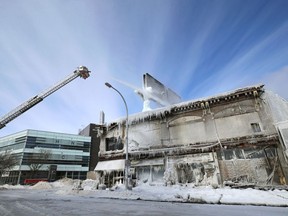 Fire crews remain on the scene a day after a fire destroyed the historic Kirkwood Block on Langside Street at Portage Avenue in Winnipeg on Thurs., Feb. 3, 2022.  KEVIN KING/Winnipeg Sun/Postmedia Network