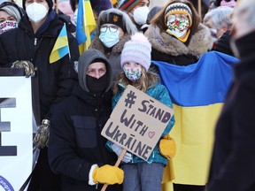 People rally outside City Hall in Winnipeg in support of Ukraine against Russian aggression on Sunday, Feb. 6, 2022.