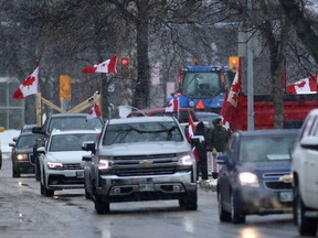 A group opposed to public health orders crowd the roadway near the Manitoba Legislature.