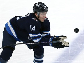 Winnipeg Jets defenceman Ville Heinola makes a mess of a basket catch against the Minnesota Wild in Winnipeg on Tues., Feb. 8, 2022.  KEVIN KING/Winnipeg Sun/Postmedia Network