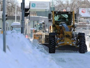 Snow-clearing equipment at work on Portage Avenue in Winnipeg on Sunday, Feb. 20, 2022.