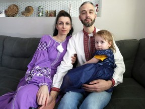 Lucas and Oleksandra Golebioski pose for a photograph with daughter Eva, 3, in the family home in Winnipeg on Mon., Feb. 28, 2022. The parents of Oleksandra are in a bomb shelter in Kiev. KEVIN KING/Winnipeg Sun/Postmedia Network