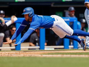 Toronto Blue Jays centre fielder George Springer scores by sliding into home plate in the first inning against the New York Yankees.