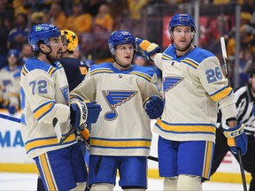 St. Louis Blues defenceman Torey Krug (47) celebrates with St. Louis Blues defenceman Justin Faulk (72) and left wing Mackenzie MacEachern (28) after a goal during the second period against the Nashville Predators at Bridgestone Arena in Nashville on Saturday, March 12, 2022.