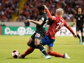 Costa Rica's Francisco Calvo (R) vies for the ball with Canada´s Jonathan David during their FIFA World Cup Qatar 2022 Concacaf qualifier match at the National Stadium in San Jose, on March 24, 2022.