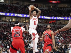 Chicago Bulls' DeMar DeRozan looks to pass the ball against the Raptors during the first quarter at United Center in Chicago on Monday, March 21, 2022.
