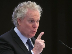 Former Quebec Premier Jean Charest speaks on energy and resources to a luncheon gathering of the Chamber of Commerce in Winnipeg, March 4, 2015.