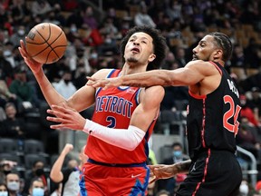 Detroit Pistons guard Cade Cunningham is fouled by Toronto Raptors center Khem Birch in the first half at Scotiabank Arena.