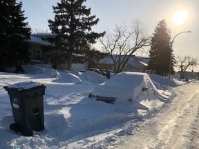 A vehicle covered in snow parked on a Winnipeg street. Coun. Janice Lukes (Waverley West) has proposed reducing the amount of time residents can keep unused vehicles on streets from 21 days to two weeks.