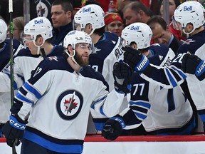 Jansen Harkins (12) of the Winnipeg Jets celebrates the bench his first goal of the second period against the Chicago Blackhawks on March 20, 2022 at the United Center in Chicago.
