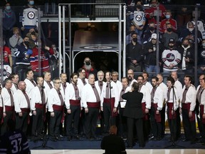 The Hoosli Ukrainian Male Choir sings the Ukrainian and Canadian anthems before the Winnipeg Jets faced the Montreal Canadiens in Winnipeg on Tuesday, March 1, 2022.