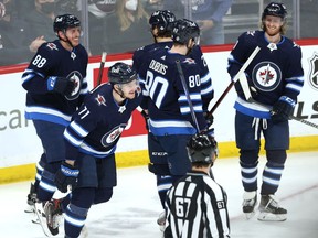 Winnipeg Jets forward Evgeny Svechnikov (second from left) celebrates his goal against the Montreal Canadiens in Winnipeg with Nate Schmidt, Nathan Beaulieu, Pierre-Luc Dubois and Kyle Connor (from left) on Tuesday, March 1, 2022.