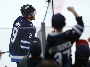 Fans celebrate a goal from Winnipeg Jets forward Andrew Copp against the Montreal Canadiens in Winnipeg on Tuesday, March 1, 2022.