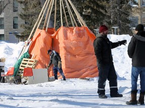 Some of a group of protesters upset over COVID-19 restrictions are seen in what is left of a camp in Memorial Park, across from the Manitoba Legislative Building, in Winnipeg on Wed., March 9, 2022. Conservation officers moved in this morning and hauled away equipment and dismantled shelters. KEVIN KING/Winnipeg Sun/Postmedia Network