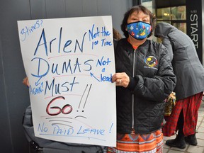 A protester holds up a sign that reads “Arlen Dumas must go” while taking part in a rally in front of the Assembly of Manitoba Chiefs head office in Winnipeg on Monday, March 21, 2022. Dumas has been accused of sexual assault by a woman who is reported to have worked with AMC, an organization that represents and advocates for 62 First Nations across Manitoba. On Friday, AMC’s Executive Council confirmed that Dumas, who has served as Grand Chief since 2017, has been suspended pending an investigation that they said will be “impartial, neutral and objective.”