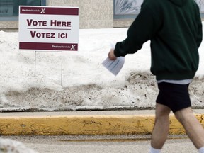A man wearing shorts has his voter identification card at the ready as he approaches the polling station in the Fort Whyte by-election at My Church Winnipeg on Wilkes Avenue on Tues., March 22, 2022.  KEVIN KING/Winnipeg Sun/Postmedia Network