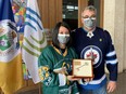 Bernadine and Toby Boulet stand with the Key to the City presented to them by Winnipeg Mayor Brian Bowman on Friday, March 25, 2022, at a ceremony at City Hall, in recognition of the awareness they continue to create on the importance of organ donation in the loving memory of their son, Logan. Logan was among 16 Humboldt Broncos hockey team players and staff who died when their bus crashed on a Saskatchewan highway on April 6, 2018. April 7 has become known as Green Shirt Day as a way to honour all the victims and families of the tragic crash, and to continue Logan’s legacy to inspire Canadians to consider becoming organ donors.