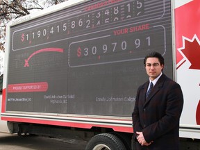 Canadian Taxpayers Federation federal director Franco Terrazzano stands next to the Canadian Taxpayers Federation’s Debt Clock outside the Manitoba Legislative Building on Kennedy Street in Winnipeg on Monday, March 28, 2022. The CTF Debt Clock is slated to be in Ottawa on April 1.