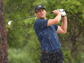 NFL player Tom Brady of the Tampa Bay Buccaneers plays a shot from the sand on the seventh hole during The Match: Champions For Charity at Medalist Golf Club on May 24, 2020 in Hobe Sound, Florida.