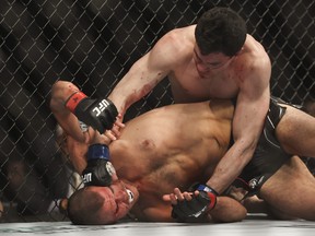 Mike Malott punches Mickey Gall during a welterweight bout during UFC 273.