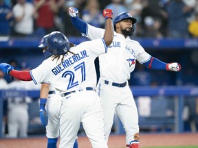 Toronto Blue Jays right fielder Teoscar Hernandez celebrates with first baseman Vladimir Guerrero Jr. after hitting a three run home run during the fifth inning against the Texas Rangers at Rogers Centre in Toronto, April 8, 2022.