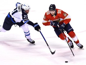 Panthers center Maxim Mamin (98) skates past Winnipeg Jets center Dominic Toninato (21) during the third period at FLA Live Arena on Friday night.