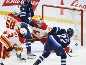 Jets’ Mason Appleton scores on Flames goaltender Dan Vladar during the second period on Friday. THE CANADIAN PRESS