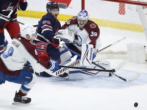 Winnipeg Jets’ Josh Morrissey can’t jam the puck past Colorado Avalanche goaltender Pavel Francouz during second period NHL action in Winnipeg last night. The Jets lost 5-4 to the division-leading Avalanche in OT.  John Woods/THE CANADIAN PRESS