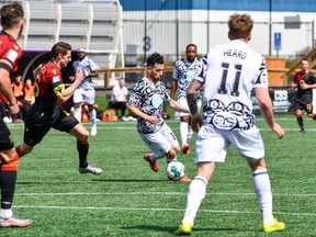 Pacific FC attacker Marco Bustos moves the ball up field against Valour FC defenders in Canadian Premier League action on Sunday, April 17, 2022 at Starlight Stadium in Victoria, B.C. as the defending Canadian Premier League champions won their second straight to open the 2022 campaign. Pacific FC won 3-2 with Bustos assisting on all three goals.