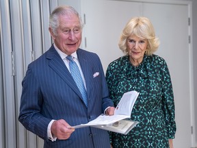 Prince Charles is flanked by Camilla, Duchess of Cornwall, as he sings an Irish song during a visit to the Irish Cultural Centre in west London Tuesday, March 15, 2022.