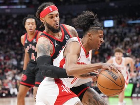 Jalen Green of the Houston Rockets drives by Gary Trent Jr. of the Toronto Raptors during the first half of their basketball game at the Scotiabank Arena on April 8, 2022 in Toronto.