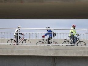 People ride bike across a bridge in Winnipeg. The province has announced $600,000 in funds for two new greenway projects in Winnipeg.