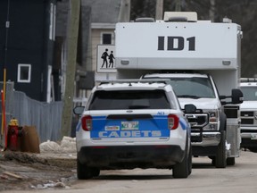Winnipeg Police vehicles outside a residence Saturday where a body was discovered Friday evening.