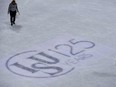 Volunteers fix the ice next to an International Skating Union (ISU) logo during the ice dance/short dance event at the ISU World Figure Skating Championships in Helsinki, Finland on March 31, 2017.