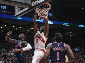 Apr 20, 2022; Toronto, Ontario, CAN; Toronto Raptors forward Precious Achiuwa (5) dunks the ball against Philadelphia 76ers forward Paul Reed (44) and guard James Harden (1) during the second half of game three of the first round for the 2022 NBA playoffs at Scotiabank Arena.