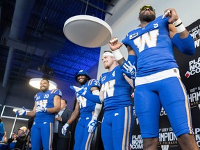 Blue Bombers (from left) Nic Demski, Brandon Alexander, Adam Bighil and Willie Jefferson show off their new-look alternate uniforms at an unveiling event last night for season-ticket holders.