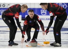 Canada skip Brad Gushue, center, delivers a stone against the Czech Republic during the men's world curling championships Saturday, April 2, 2022, in Las Vegas.