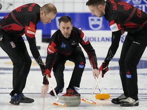 Canada skip Brad Gushue throws a rock for sweepers Geoff Walker and Brent Gallant during the LGT World Men’s Curling Championship at Orleans Arena in Las Vegas on April 2, 2022.