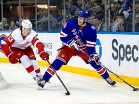 New York Rangers center Andrew Copp (18) looks for room to pass while Detroit Red Wings defenceman Moritz Seider (53) checks him during the second period at Madison Square Garden in New York on Saturday, April 16, 2022.