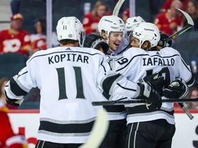 Los Angeles Kings left wing Alex Iafallo (19) celebrates his goal with teammates against the Calgary Flames during the second period at Scotiabank Saddledome in Calgary on Thursday, March 31, 2022.