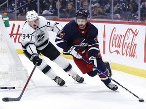 Los Angeles Kings right wing Arthur Kaliyev (34) chases down Winnipeg Jets defenceman Josh Morrissey (44) in the second period at Canada Life Centre in Winnipeg on Saturday, April 2, 2022.
