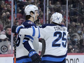 Winnipeg Jets forward Morgan Barron (36) celebrates with forward Paul Stasny (25) after scoring a goal against the Montreal Canadiens during the second period at the Bell Centre in Montreal on Monday, April 11, 2022.