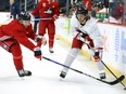 Kyle Connor (right) protects the puck from Ville Heinola during Winnipeg Jets practice in Winnipeg on Monday April 4, 2022.