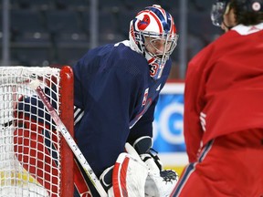 Connor Hellebuyck follows the play during Jets practice in Winnipeg on Tuesday, April 5, 2022.