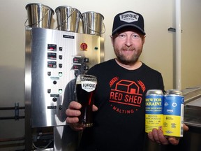 Operations manager Matthew Wolff displays Red Eyes American Red Ale, a collaborative brew to raise funds for humanitarian relief in Ukraine, at Torque Brewing on King Edward Street in Winnipeg on Thursday, April 7, 2022.